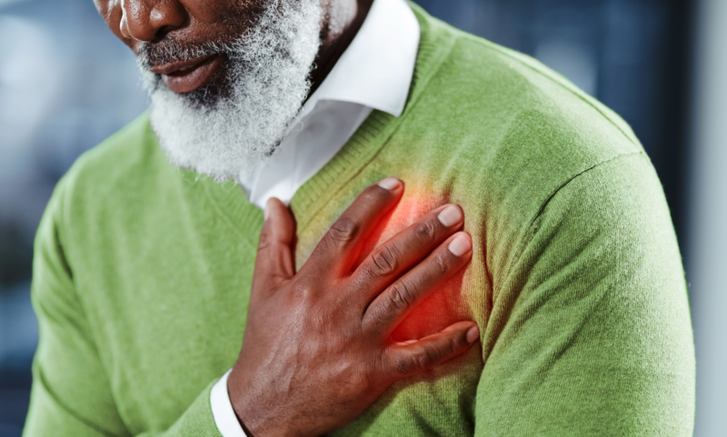 Man holding his hand over is heart to emphasize pain