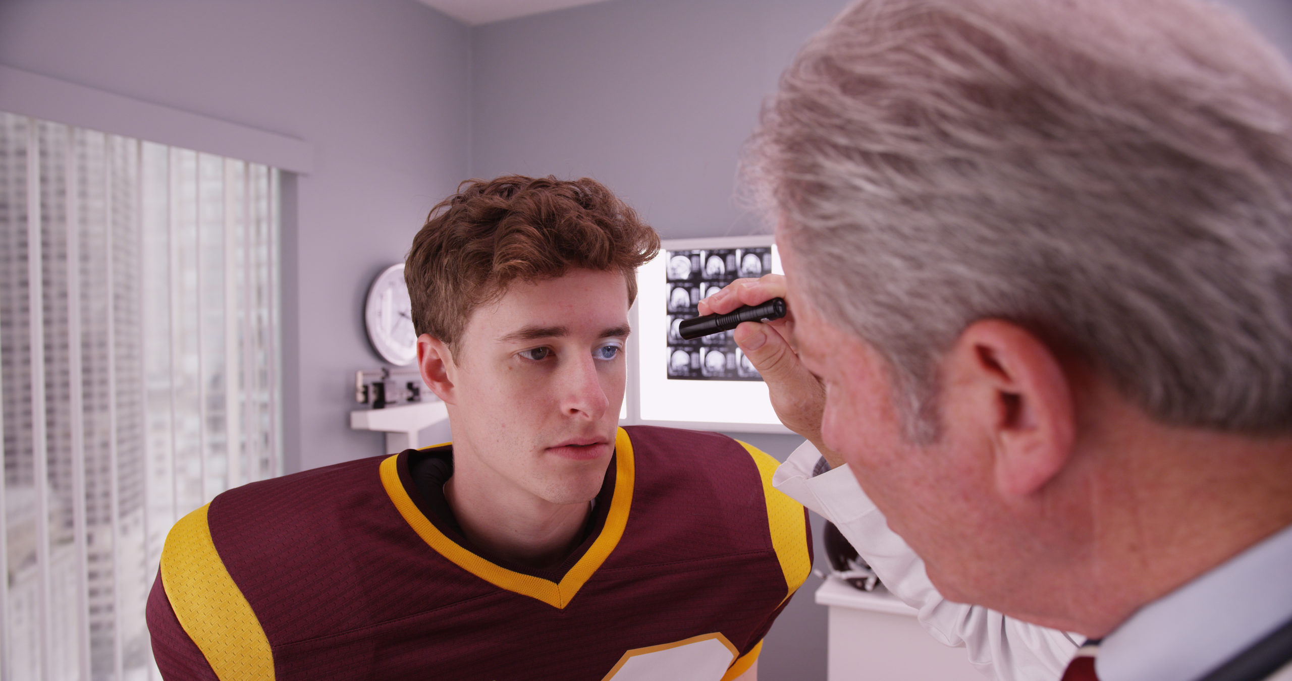 Football player being checked for concussion